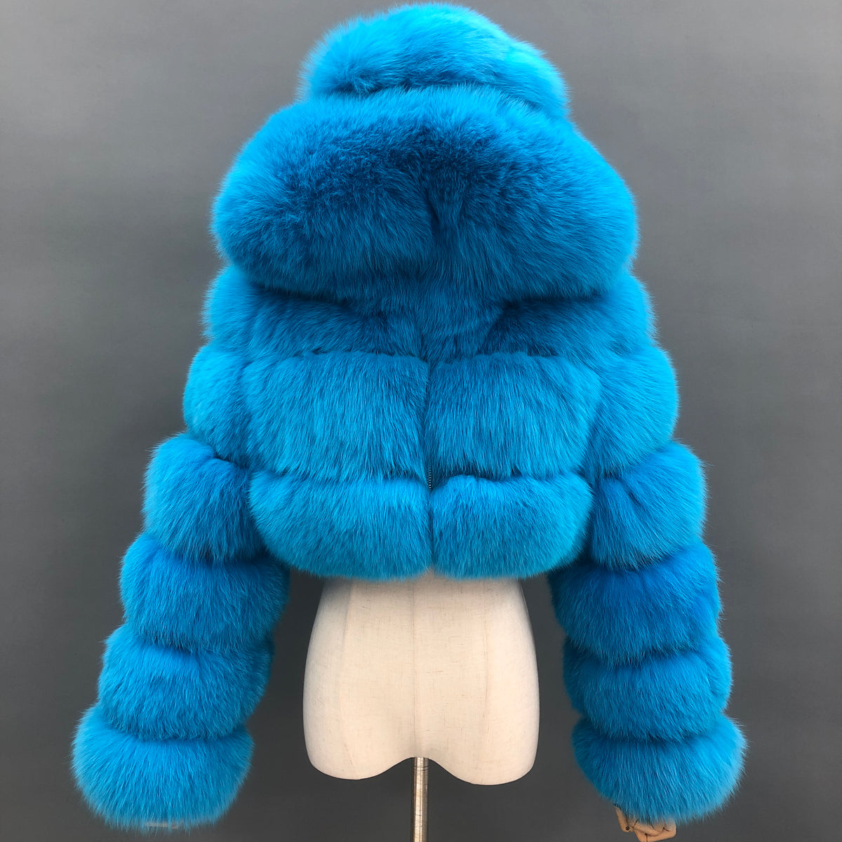 Blue real fox fur three-row cropped jacket with oversized hood, front view
