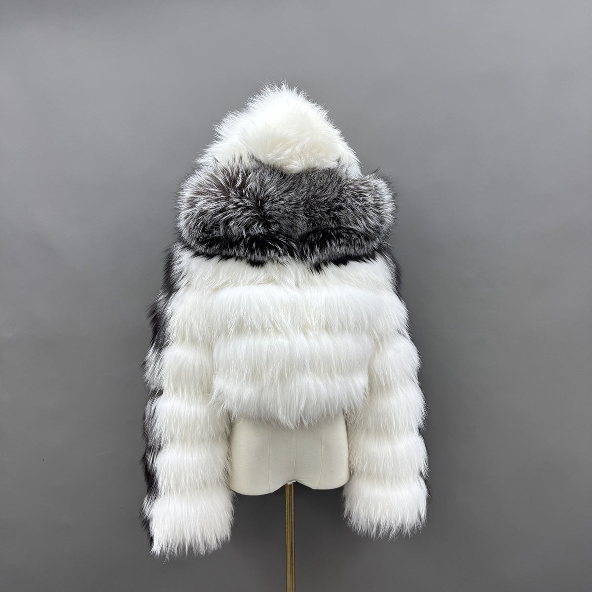 Mixed silver fox and raccoon dog fur cropped jacket with hood raised, rear view