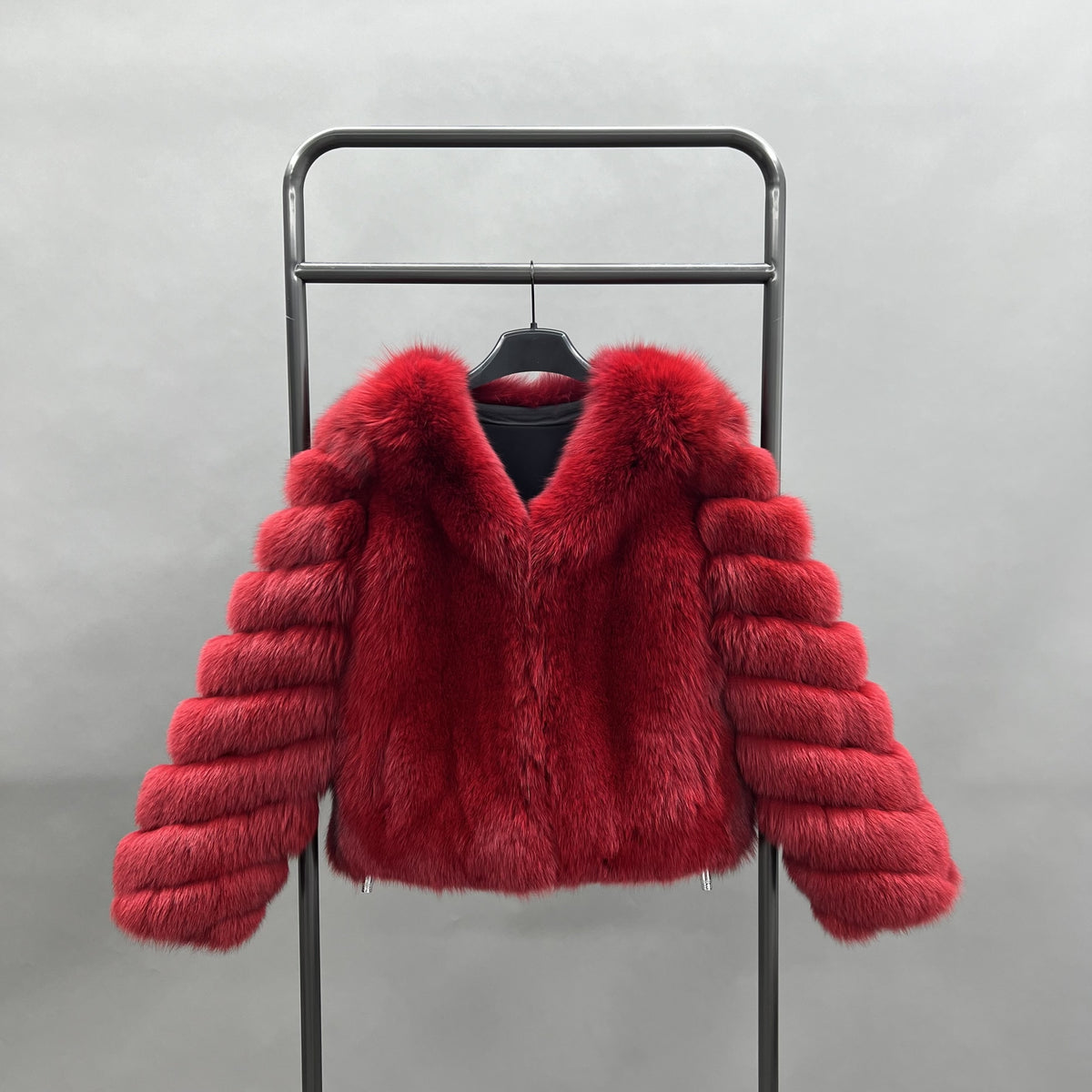 Red real fox fur short V-neck jacket displayed on a hanger with banded sleeves