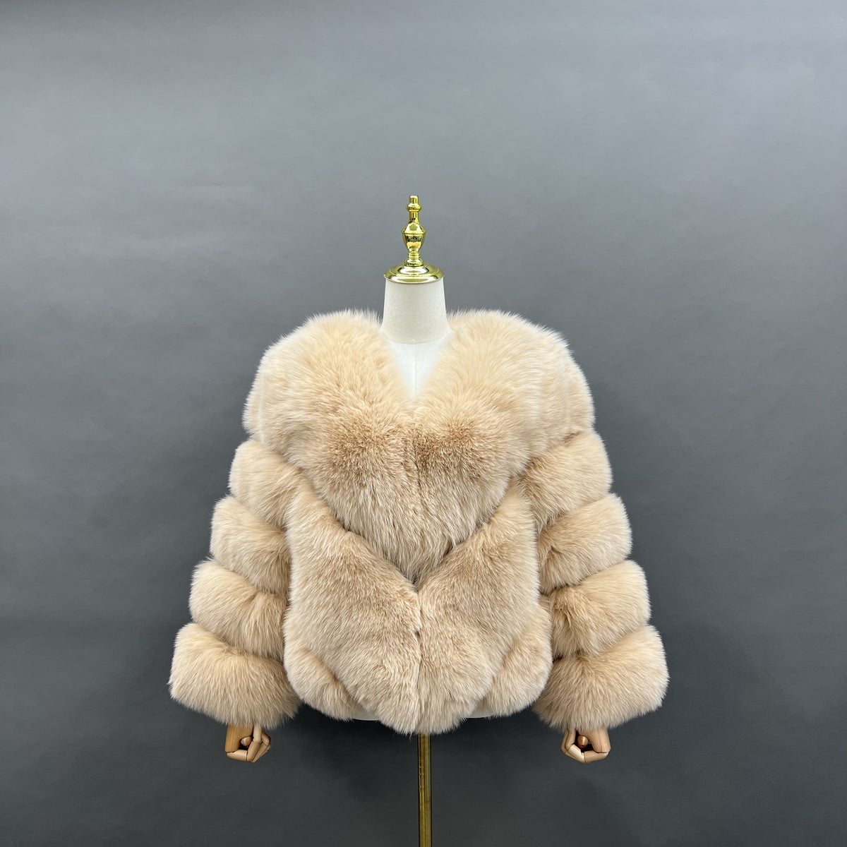 Women's white real fox fur short jacket with V-shaped chevron panels and horizontally segmented sleeves, front view