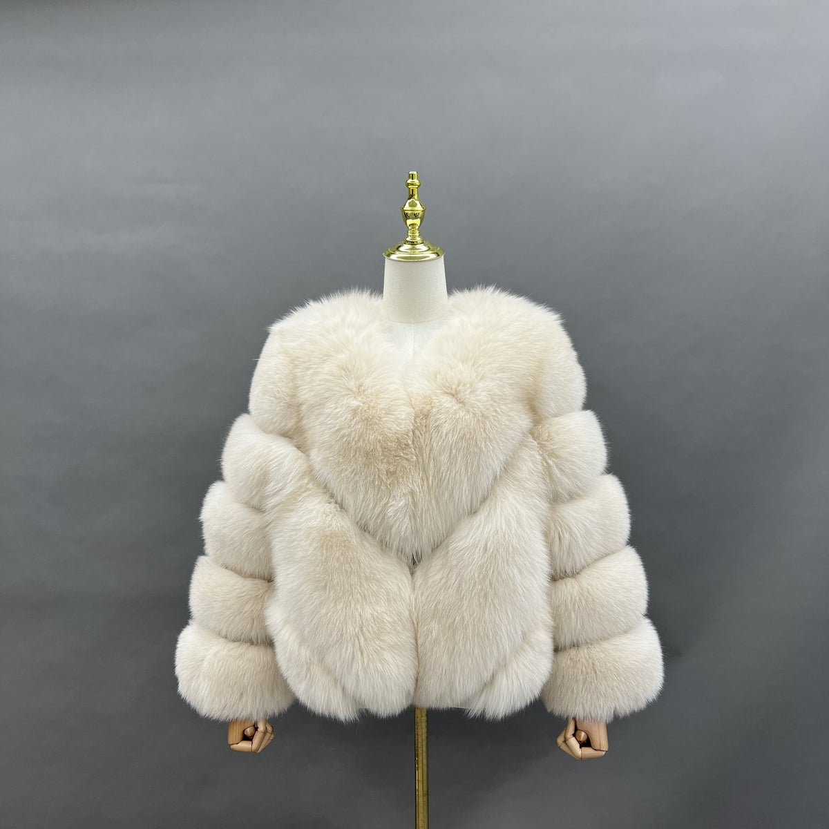 Women's warm beige fox fur collarless short jacket with V-shaped panels, front view