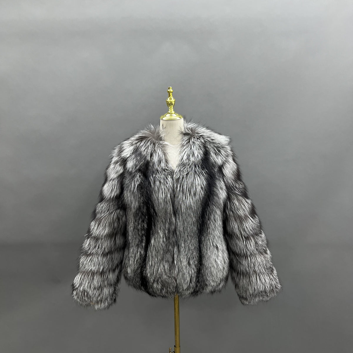 Silver fox fur short V-neck jacket with horizontally segmented sleeves, front view